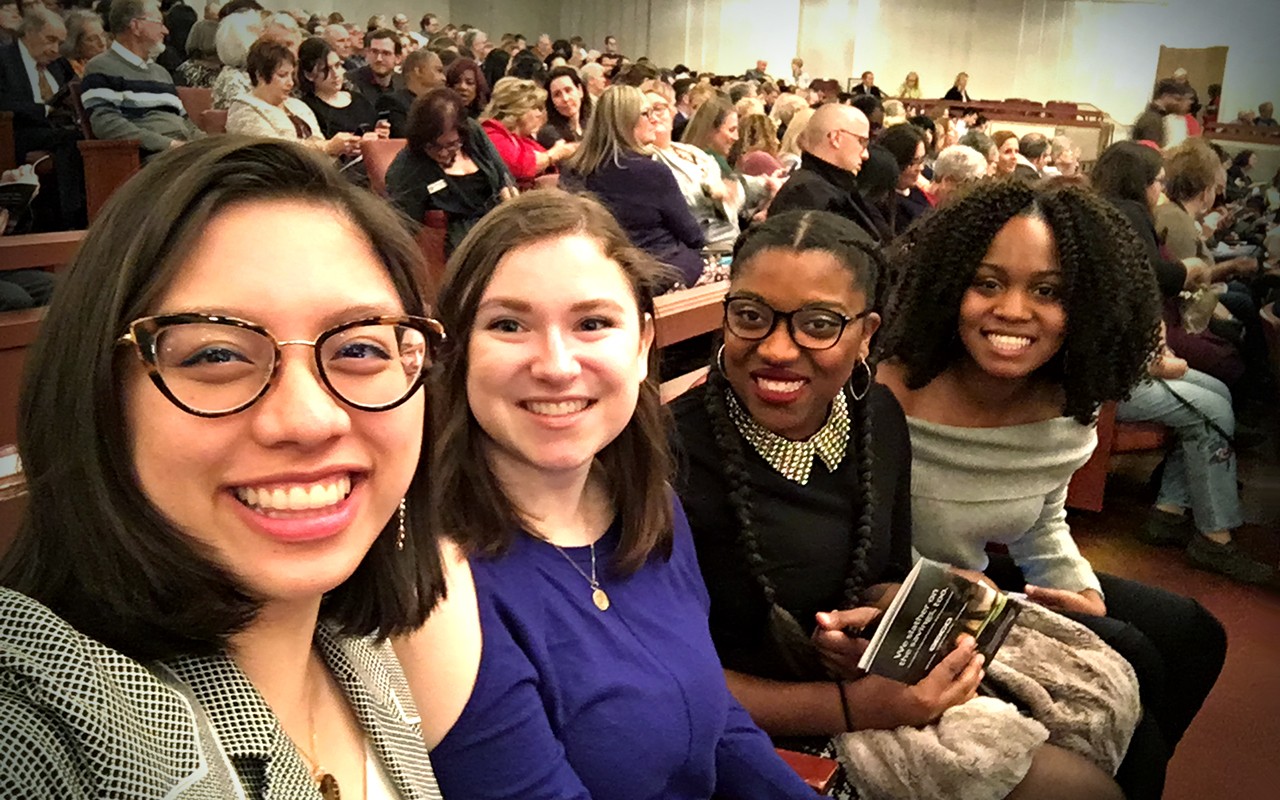 Four female Arts Administration students smile at a National Symphony Orchestra performance