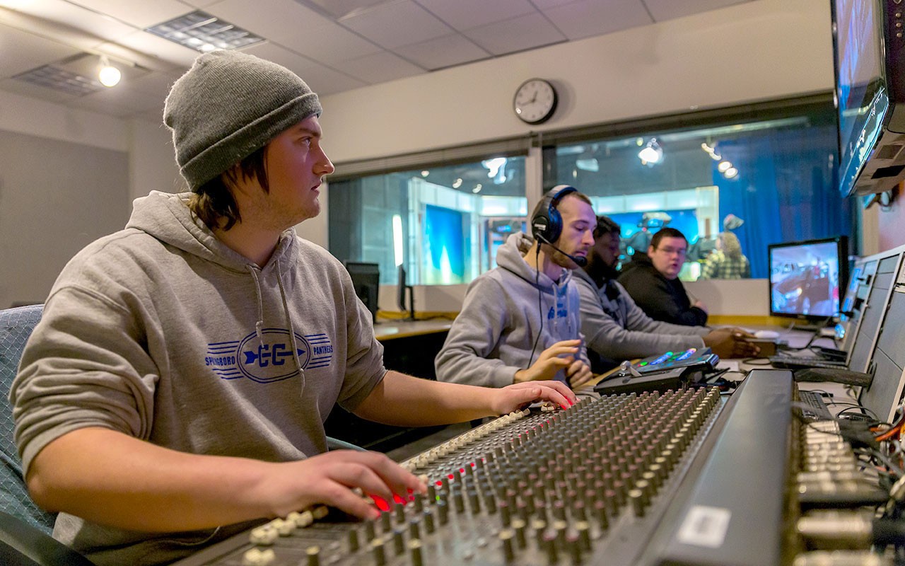 Four Media Production students work the control panel in the Bartlett Television Control Room